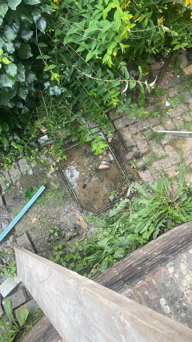 Water standing in an open outside inspection chamber.