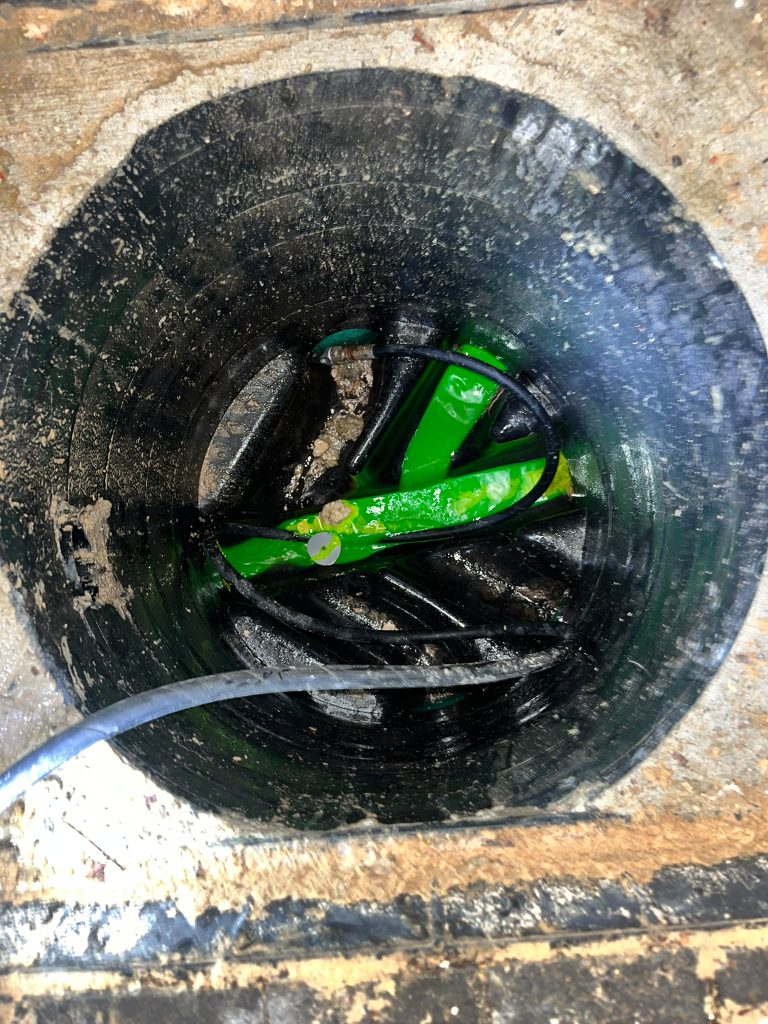Green testing dye in an Enfield drain chamber after a wipes blockage was cleared