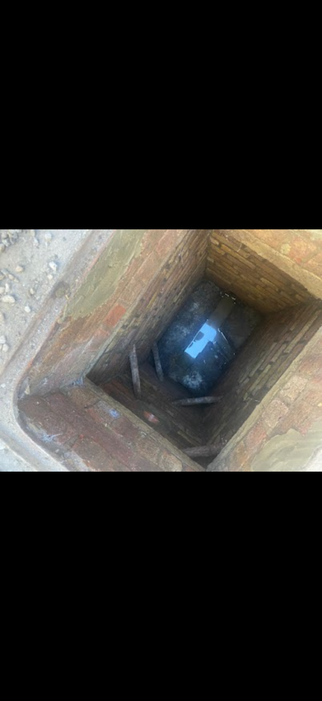 View into a deep brick drainage chamber in Hertford