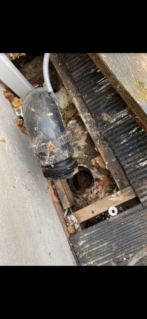 Exposed drain inlet beside decking in Milton Keynes