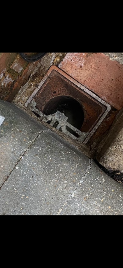 Open gully beside paving at a Milton Keynes property