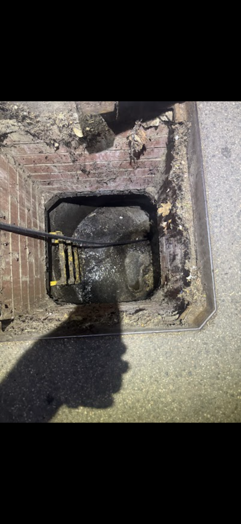 Drainage hose in a deep brick inspection chamber in Stansted