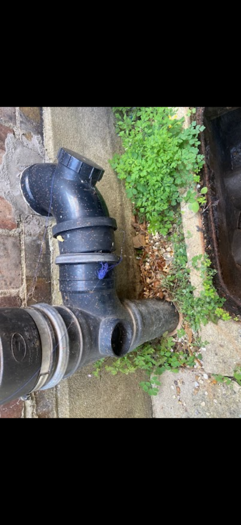 External black drainage pipework with access fittings in Stevenage